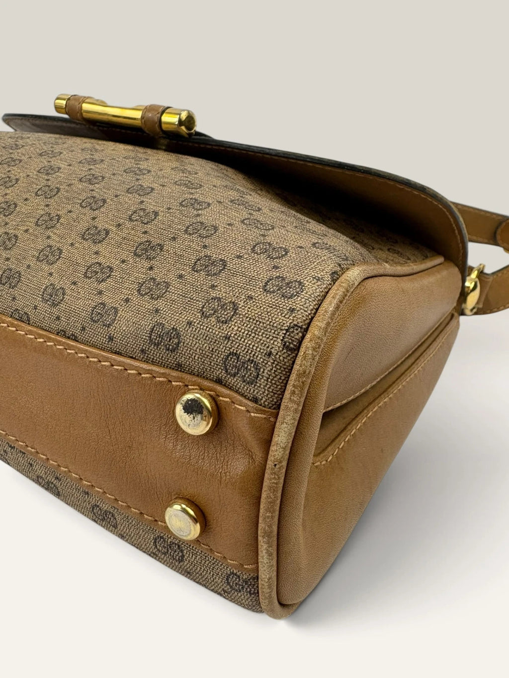 Gucci beige GG monogram canvas shoulder bag with brown leather trim and gold-tone hardware.