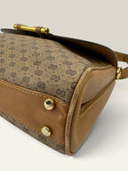 Gucci beige GG monogram canvas shoulder bag with brown leather trim and gold-tone hardware.