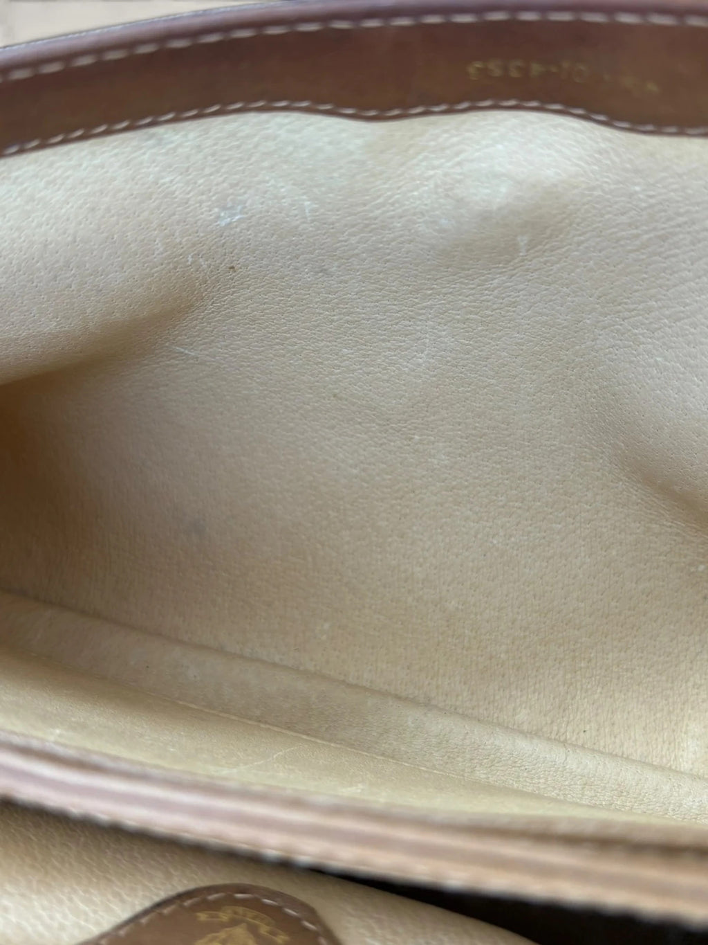 Gucci beige GG monogram canvas shoulder bag with brown leather trim and gold-tone hardware.