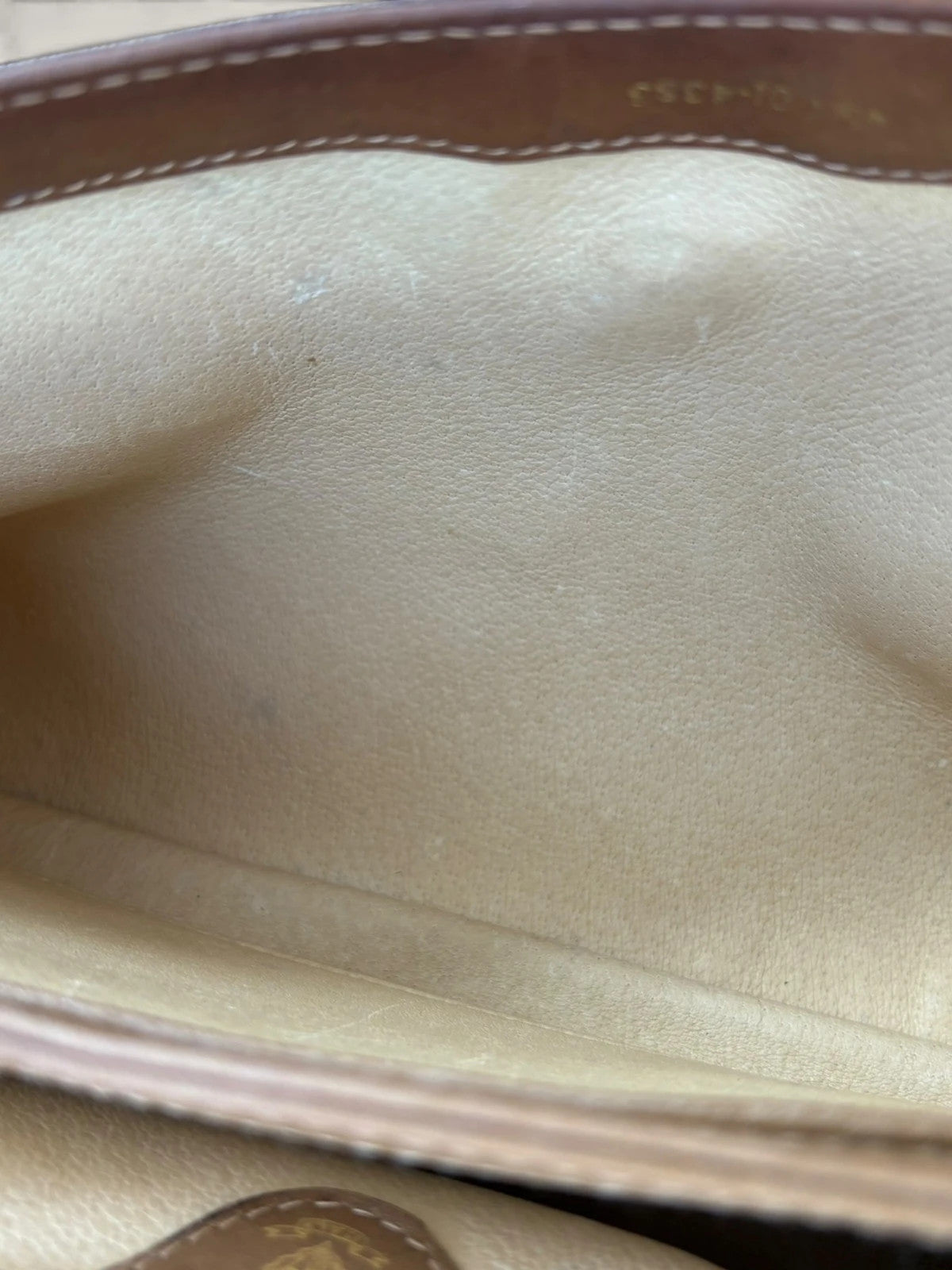 Gucci beige GG monogram canvas shoulder bag with brown leather trim and gold-tone hardware.