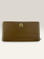 BVLGARI brown leather purse with orange accents and iconic hardware, showing vintage wear.