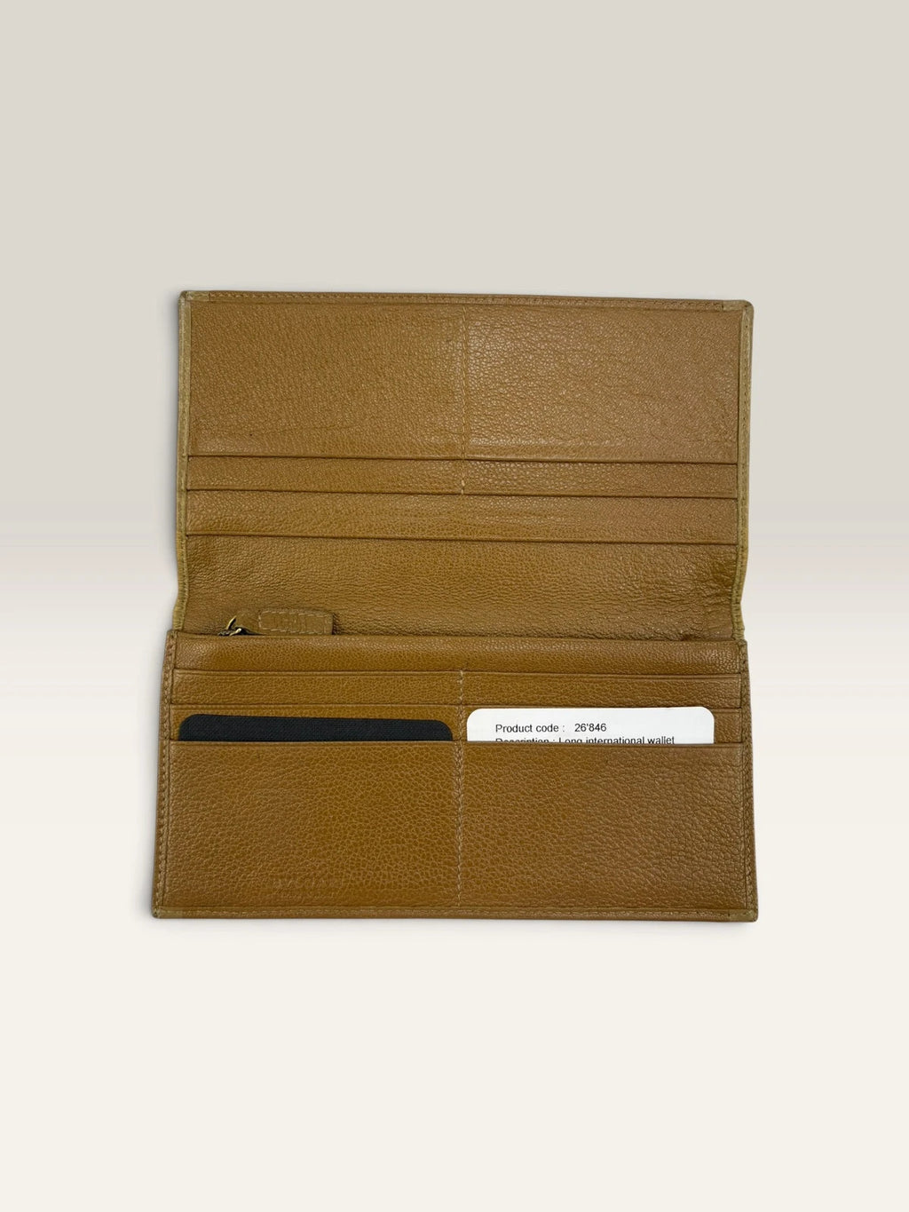 BVLGARI brown leather purse with orange accents and iconic hardware, showing vintage wear.