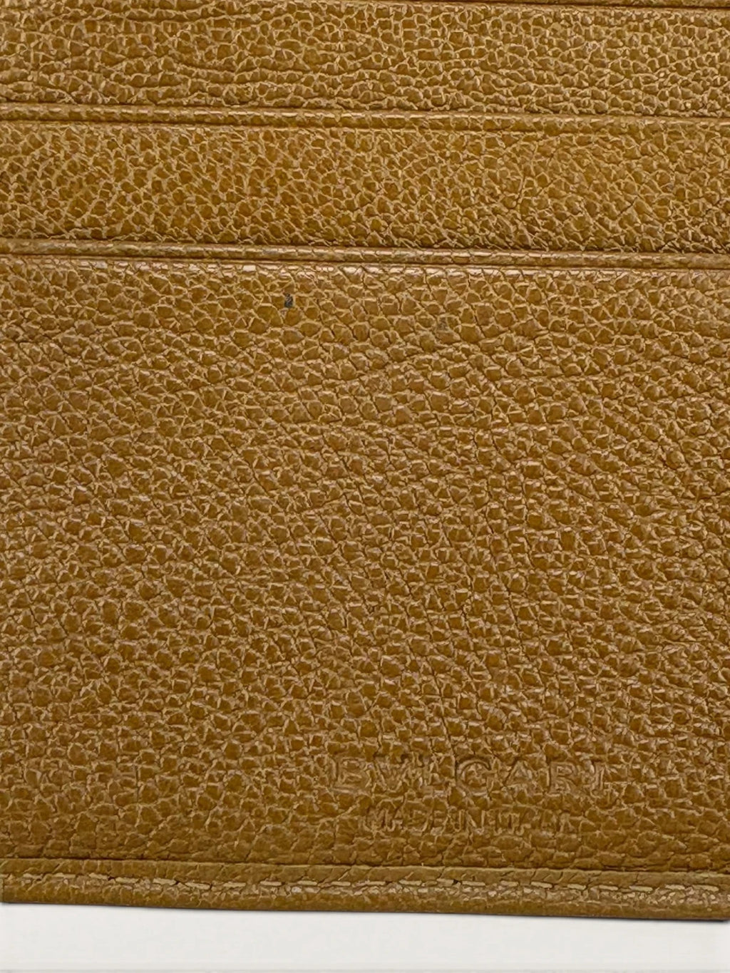 BVLGARI brown leather purse with orange accents and iconic hardware, showing vintage wear.