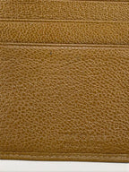 BVLGARI brown leather purse with orange accents and iconic hardware, showing vintage wear.