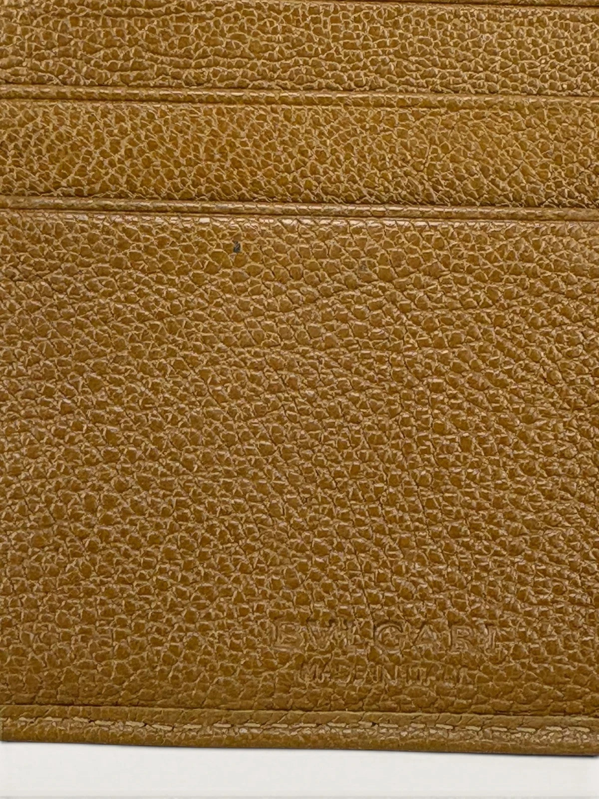 BVLGARI brown leather purse with orange accents and iconic hardware, showing vintage wear.