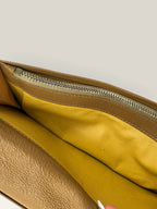 BVLGARI brown leather purse with orange accents and iconic hardware, showing vintage wear.
