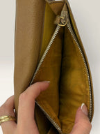 BVLGARI brown leather purse with orange accents and iconic hardware, showing vintage wear.
