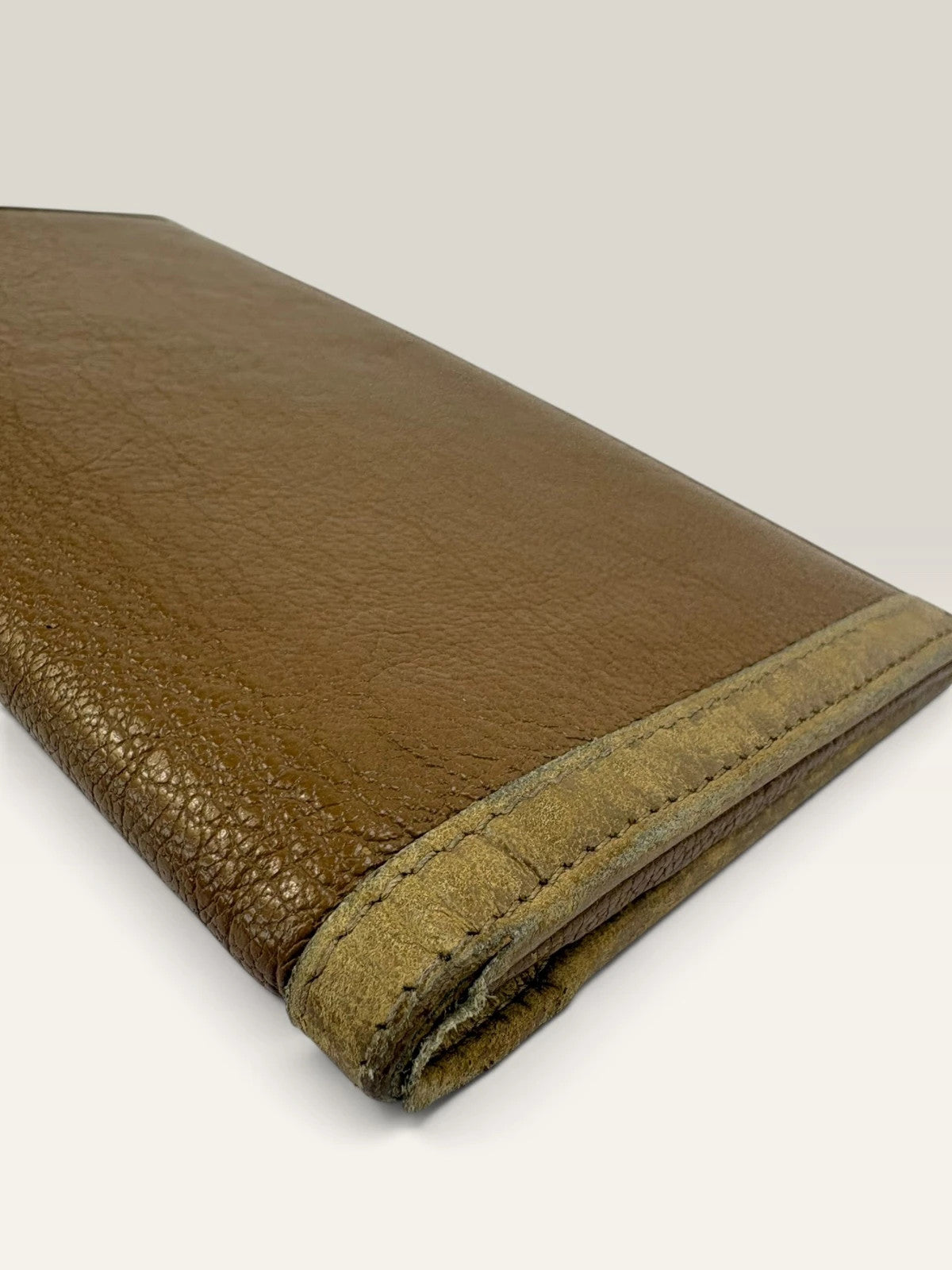 BVLGARI brown leather purse with orange accents and iconic hardware, showing vintage wear.