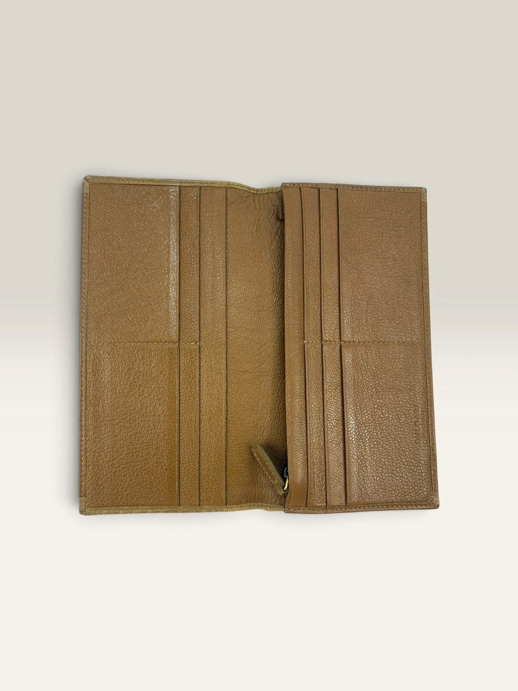 BVLGARI brown leather purse with orange accents and iconic hardware, showing vintage wear.
