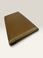 BVLGARI brown leather purse with orange accents and iconic hardware, showing vintage wear.