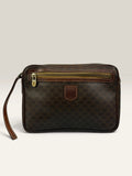 CELINE brown wristlet pouch with monogram canvas, leather trim, and gold-tone hardware.