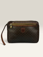 CELINE brown wristlet pouch with monogram canvas, leather trim, and gold-tone hardware.