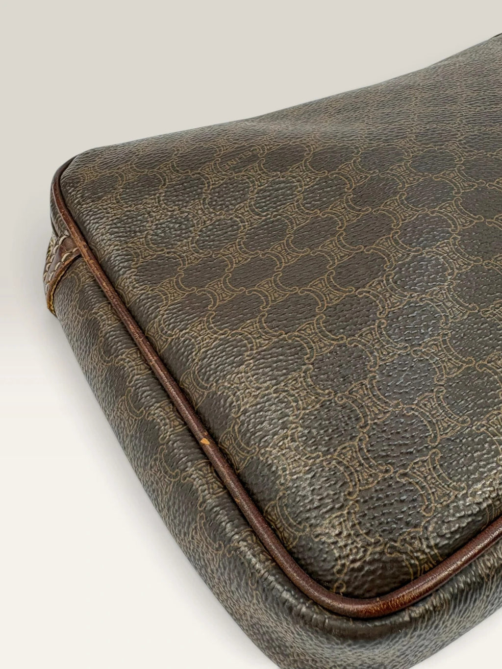 CELINE brown wristlet pouch with monogram canvas, leather trim, and gold-tone hardware.