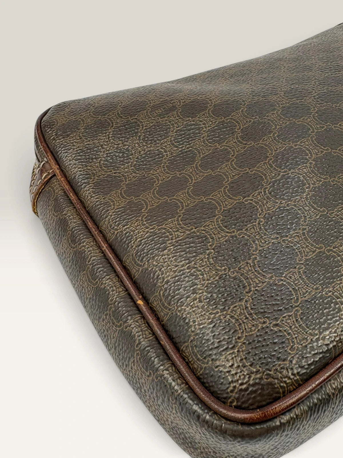 CELINE brown wristlet pouch with monogram canvas, leather trim, and gold-tone hardware.