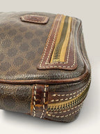 CELINE brown wristlet pouch with monogram canvas, leather trim, and gold-tone hardware.