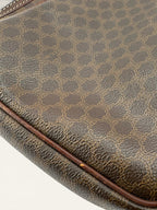 CELINE brown wristlet pouch with monogram canvas, leather trim, and gold-tone hardware.