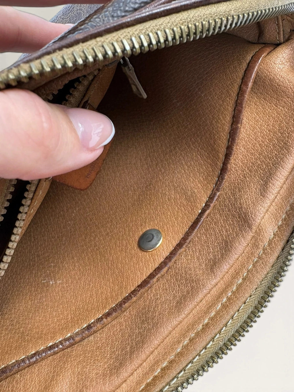 CELINE brown wristlet pouch with monogram canvas, leather trim, and gold-tone hardware.