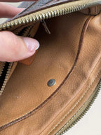 CELINE brown wristlet pouch with monogram canvas, leather trim, and gold-tone hardware.