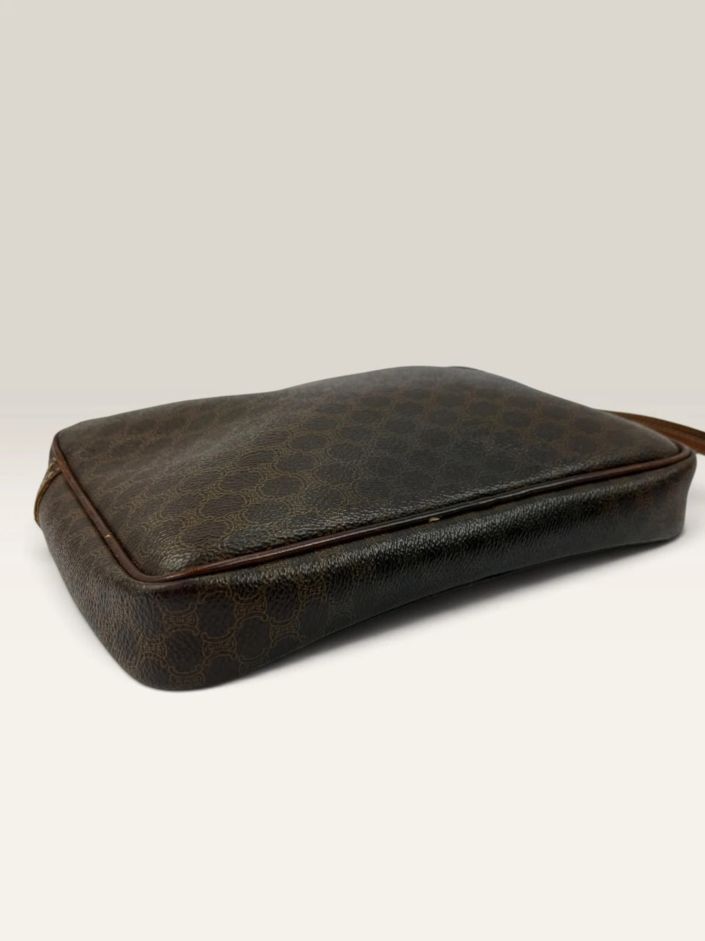 CELINE brown wristlet pouch with monogram canvas, leather trim, and gold-tone hardware.