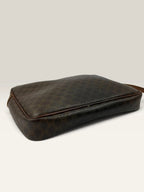 CELINE brown wristlet pouch with monogram canvas, leather trim, and gold-tone hardware.