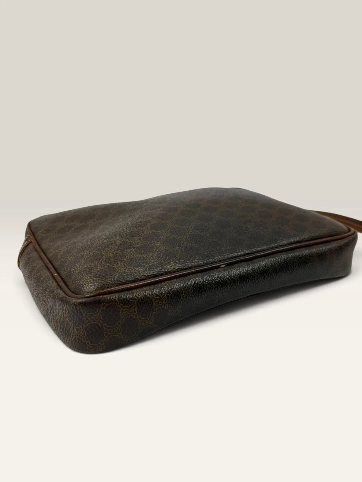 CELINE brown wristlet pouch with monogram canvas, leather trim, and gold-tone hardware.