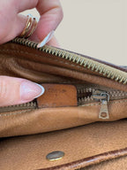 CELINE brown wristlet pouch with monogram canvas, leather trim, and gold-tone hardware.