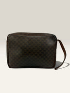 CELINE brown wristlet pouch with monogram canvas, leather trim, and gold-tone hardware.