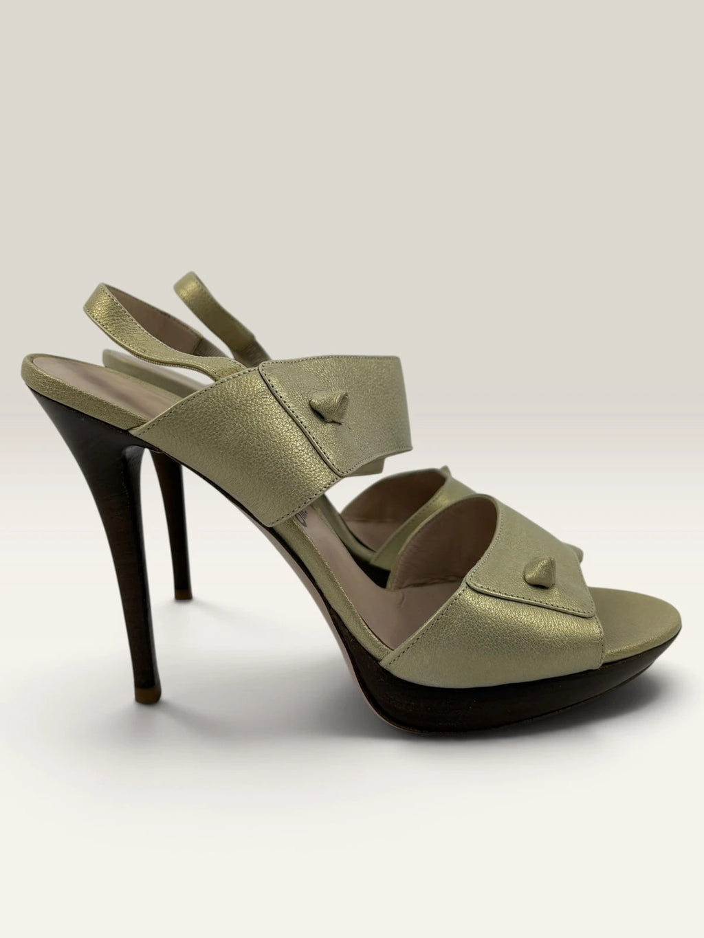 Salvatore Ferragamo beige leather slingback heels with gold accents and wooden heel.