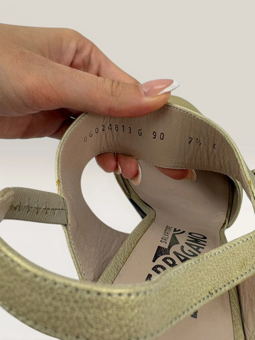 Salvatore Ferragamo beige leather slingback heels with gold accents and wooden heel.