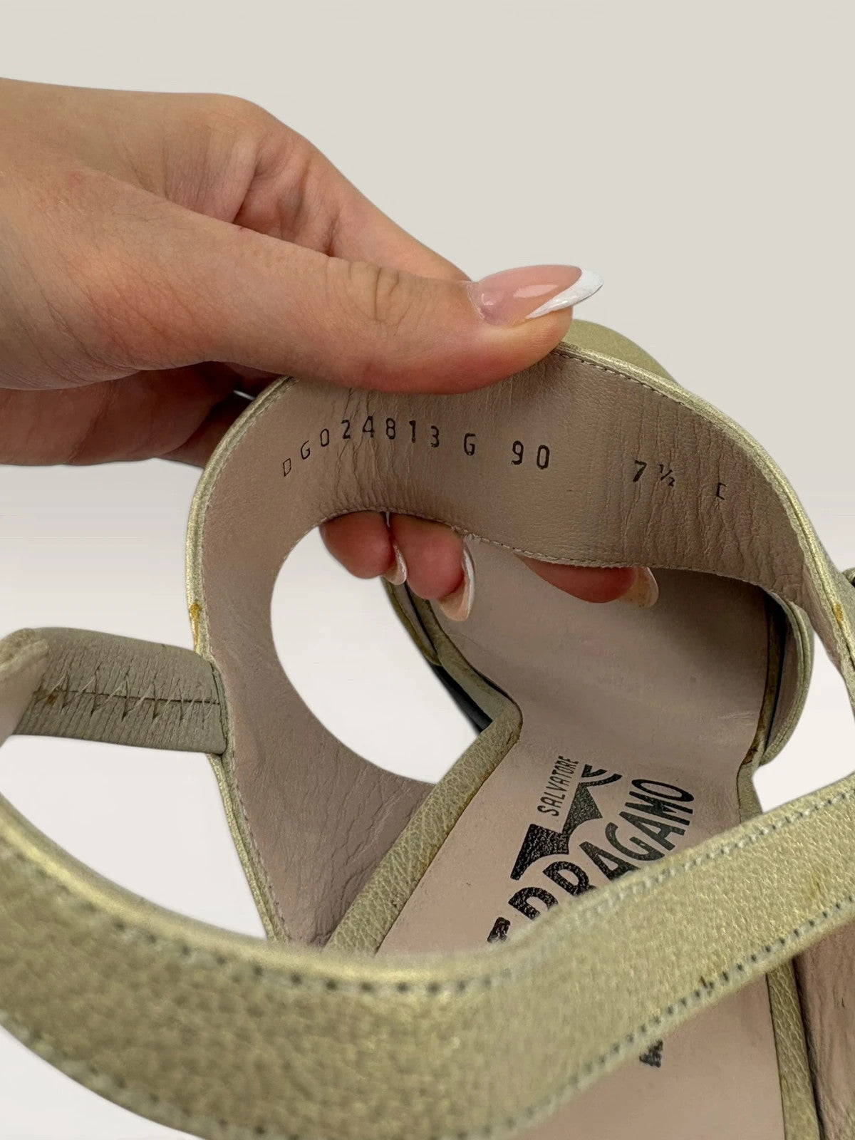 Salvatore Ferragamo beige leather slingback heels with gold accents and wooden heel.