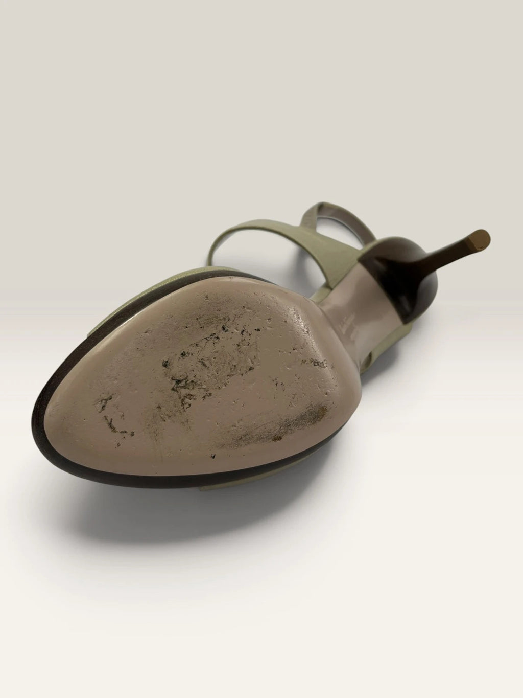 Salvatore Ferragamo beige leather slingback heels with gold accents and wooden heel.