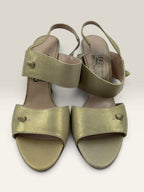 Salvatore Ferragamo beige leather slingback heels with gold accents and wooden heel.