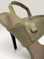 Salvatore Ferragamo beige leather slingback heels with gold accents and wooden heel.