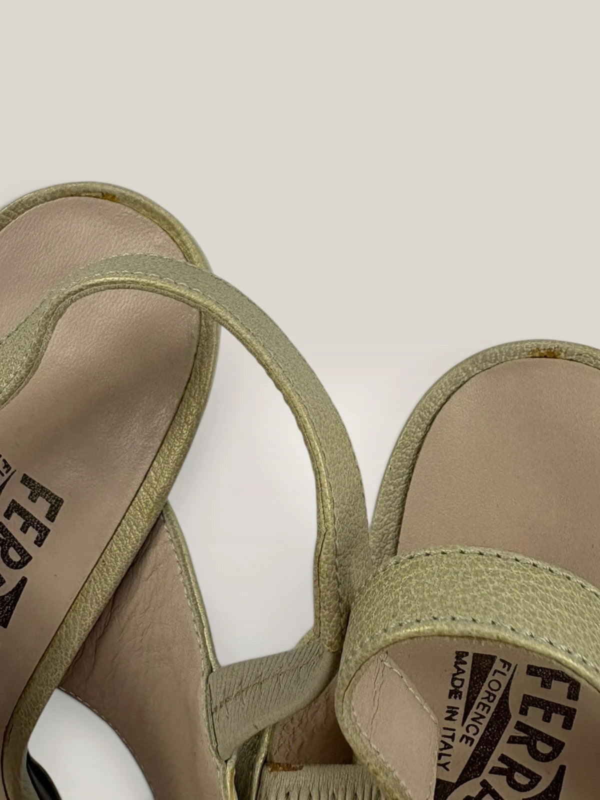 Salvatore Ferragamo beige leather slingback heels with gold accents and wooden heel.