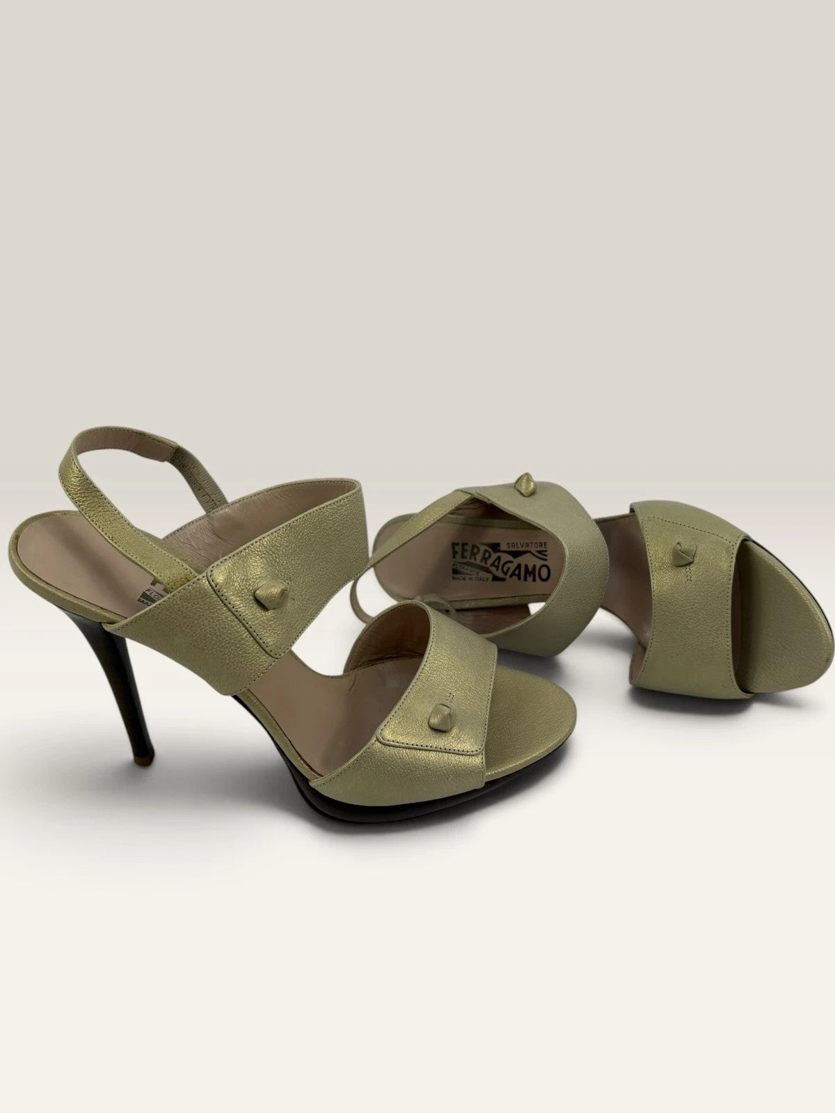 Salvatore Ferragamo beige leather slingback heels with gold accents and wooden heel.