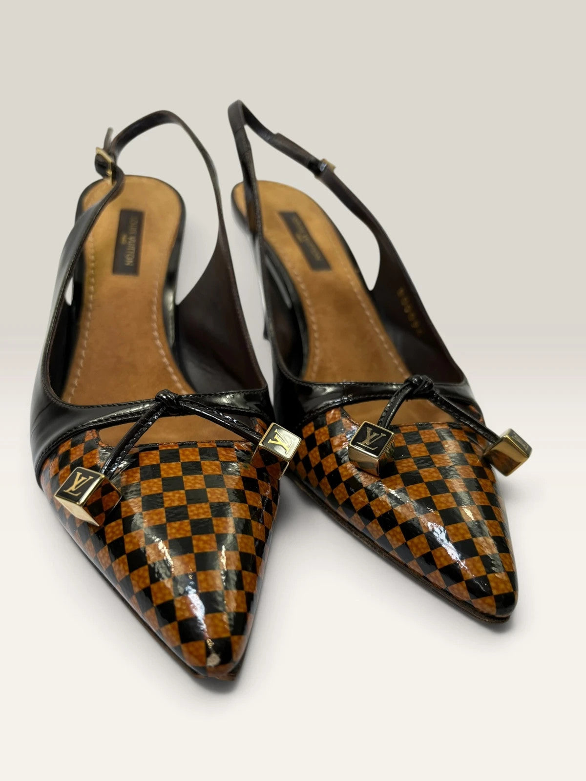 Louis Vuitton slingback heels black and brown patent leather with Damier checkerboard pattern.