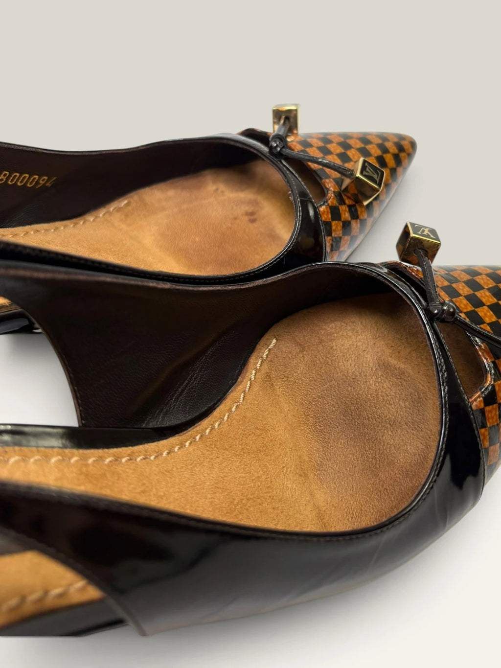 Louis Vuitton slingback heels black and brown patent leather with Damier checkerboard pattern.