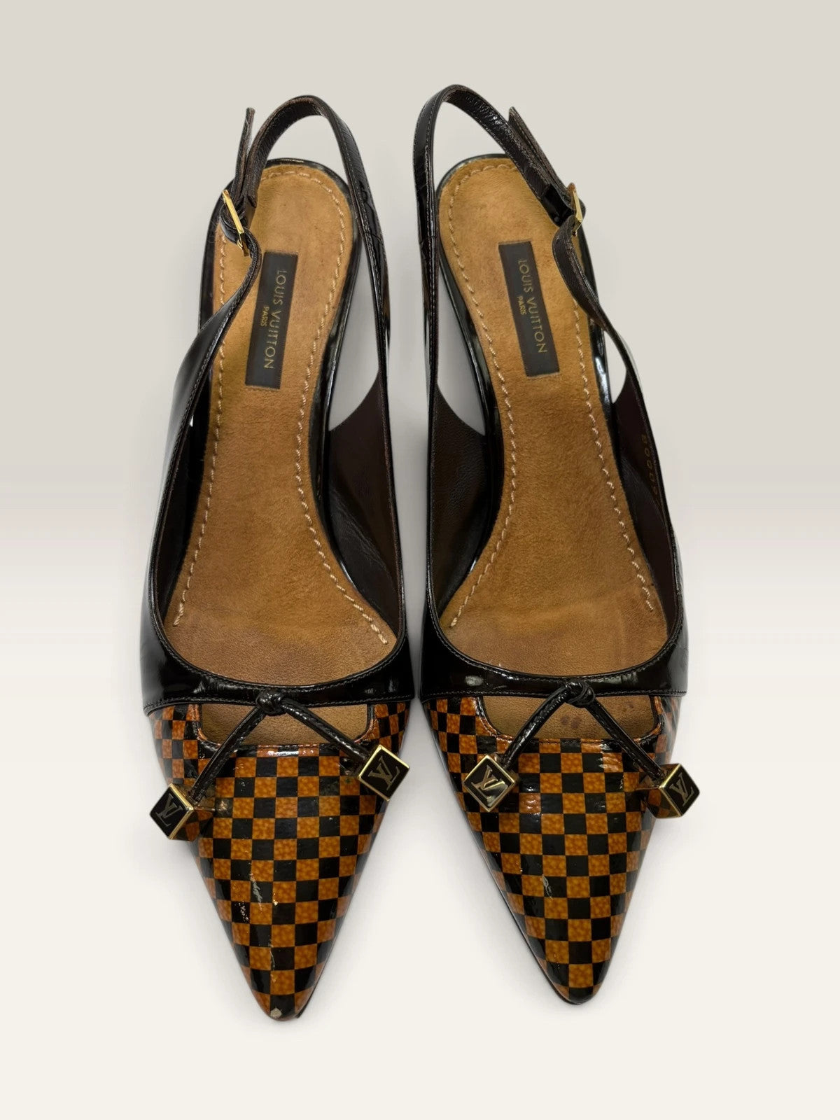 Louis Vuitton slingback heels black and brown patent leather with Damier checkerboard pattern.