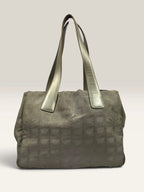 Chanel grey jacquard nylon tote with interlocking CC logo and leather shoulder straps.