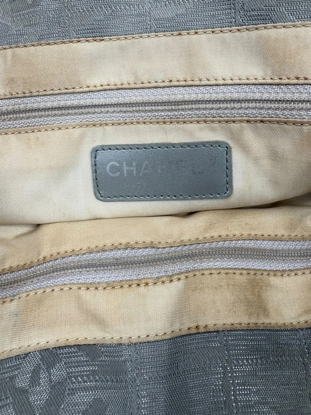 Chanel grey jacquard nylon tote with interlocking CC logo and leather shoulder straps.