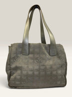 Chanel grey jacquard nylon tote with interlocking CC logo and leather shoulder straps.