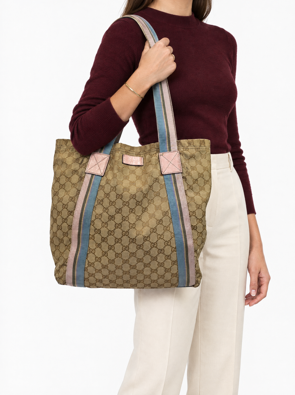 Styled photo of the vintage Gucci GG canvas tote bag carried on the shoulder by a model