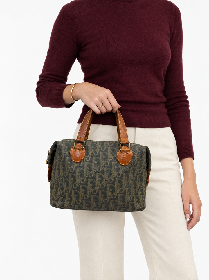 Styled photo of the vintage Christian Dior brown Trotter Boston bag carried by a model