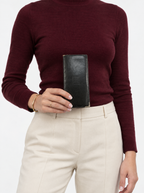 Styled photo of the Givenchy black leather long wallet held by a model