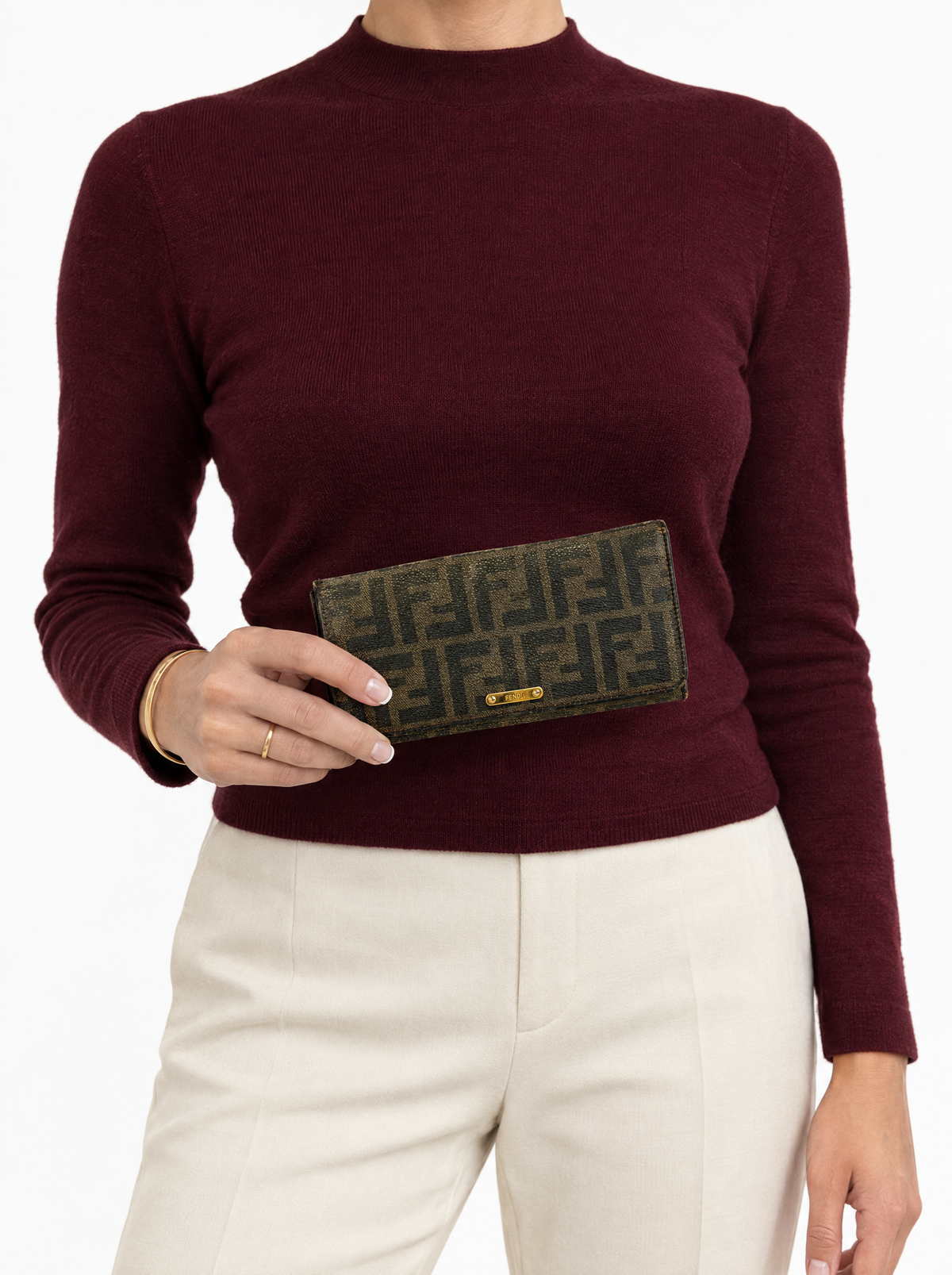 Styled photo of the vintage Fendi Zucca long wallet held by a model