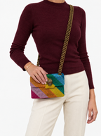 Styled photo of the Kurt Geiger London Mini Kensington rainbow crystal bag worn crossbody by a model