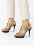 Styled photo of the vintage Salvatore Ferragamo champagne slingback heels worn by a model
