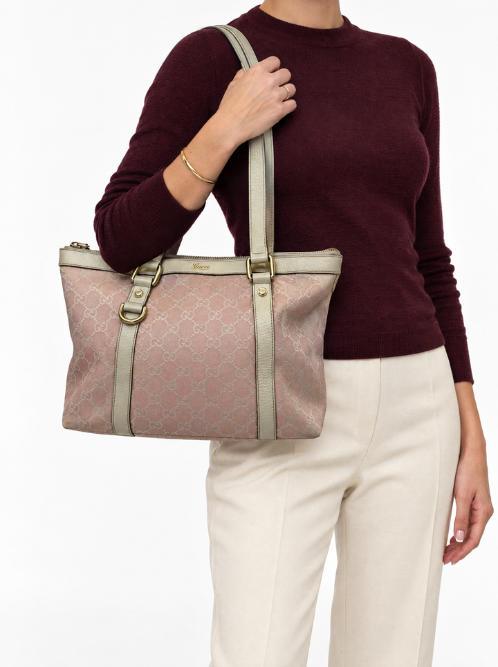 Styled photo of the vintage Gucci Abbey pink tote carried on the shoulder by a model