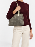 Styled photo of the Chanel New Travel Line small tote carried on the shoulder by a model